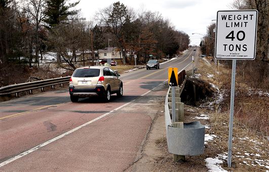 Traffic crosses a bridge over Otter Creek Thursday on heavily traveled Prill Road near the southeast city limits of Eau Claire. The road, which connects with the Oakwood Mall area, has been identified as one of the Eau Claire County roadways most in need of reconstruction. Photo credit: Steve Kinderman